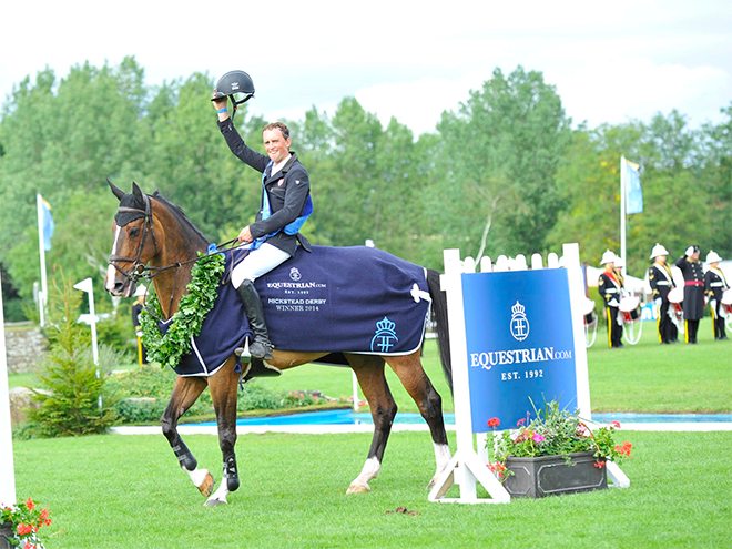 Trevor Breen celebrating on horseback after winning the Hickstead Derby